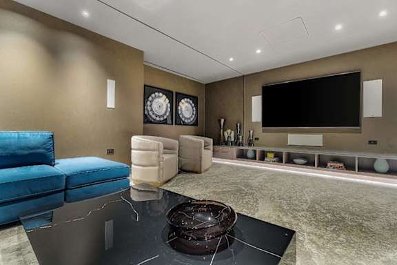 A modern living room with a blue sofa and a black coffee table.