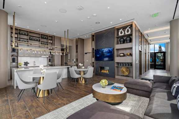 A modern living room with a dining area and a fireplace.