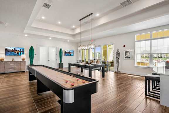 A room with a pool table and a bar.
