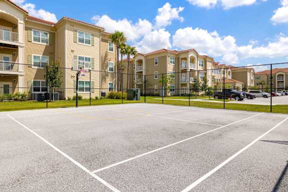 A parking lot in front of apartment buildings.