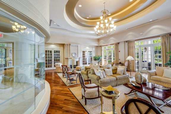 A spacious living room with a curved ceiling and a chandelier.