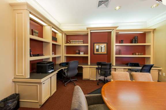A conference room with a long table and chairs.