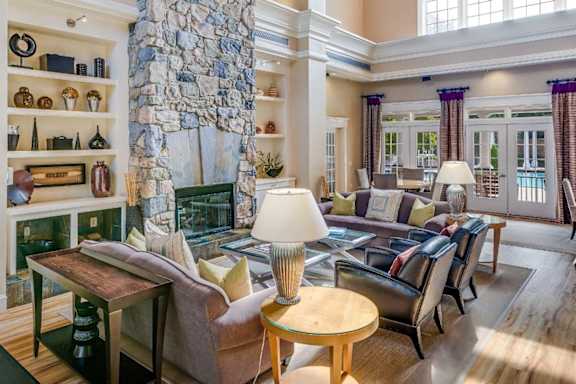 A living room with a stone pillar and a fireplace.