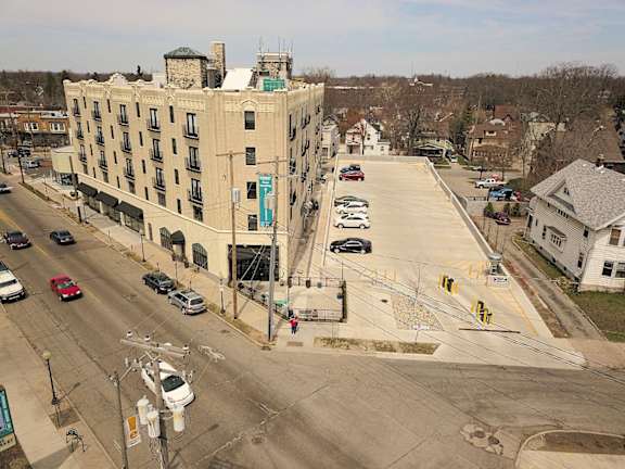 A large building with a parking lot in front of it.