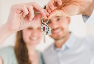 A person is handing over a key to another person. at Tela Verde, Glendale, Arizona
