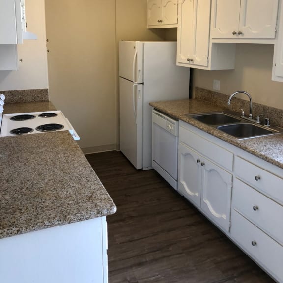 a kitchen with white cabinets and white appliances