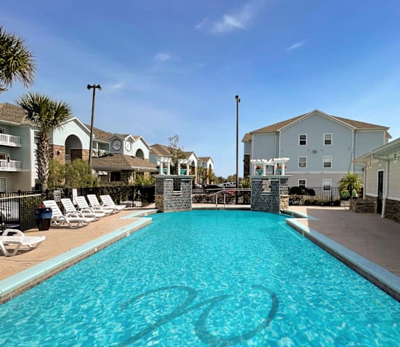 A swimming pool with a stone pillar in the middle of it.