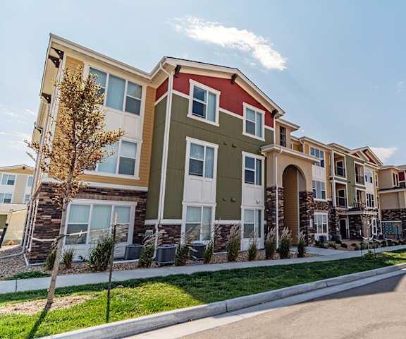 a row of town houses with a street in front of them