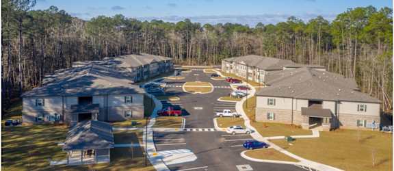 A bird's eye view of a residential area with houses and cars. at Arbours at Satsuma Apartments, Mobile, AL, 36572