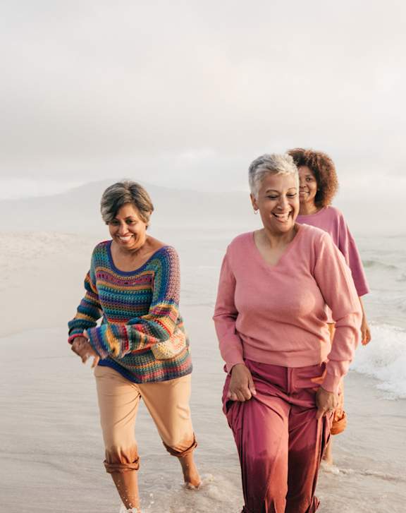 Three women walking on the beach at Coastal Senior Residences at The Park Lane, Monterey, California