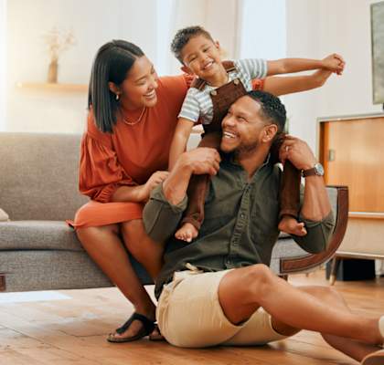 A family of three is having fun in their living room.