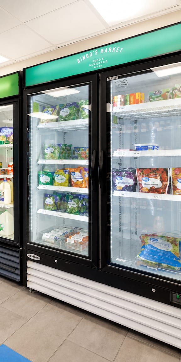 A row of refrigerators in a store.