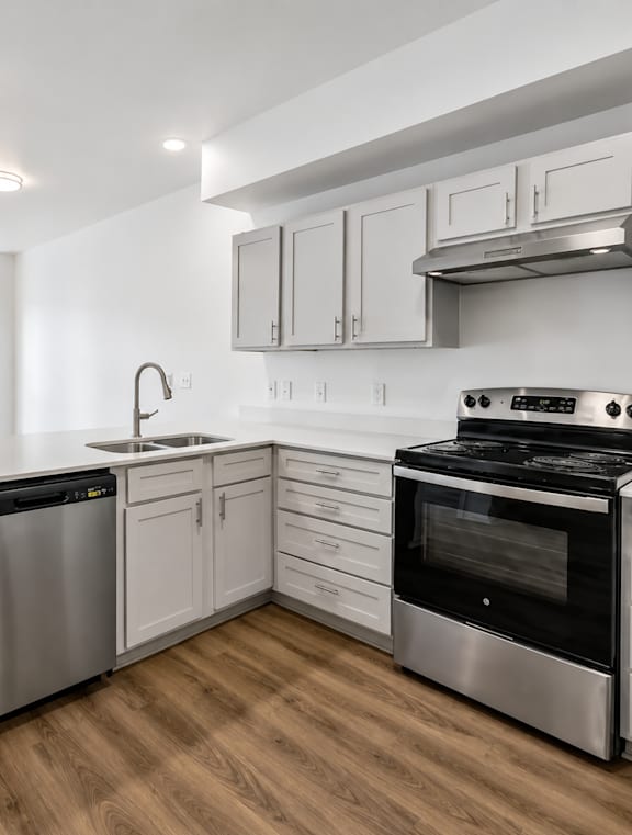 A modern kitchen with a stainless steel dishwasher and oven.