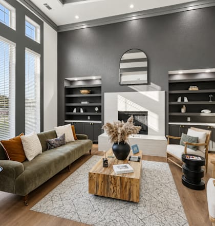 A modern living room with a green sofa and a wooden coffee table.