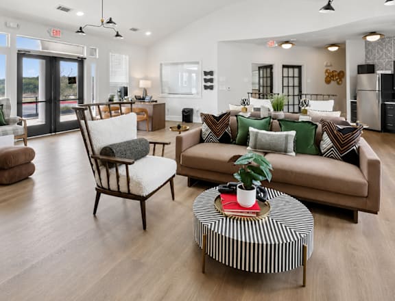 A living room with a brown couch and a striped coffee table.