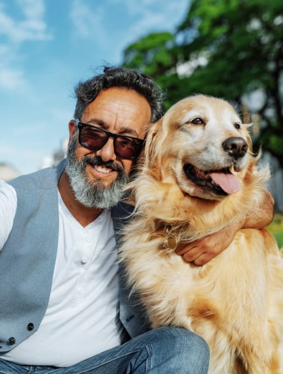 a man and his dog taking a picture with a cell phone