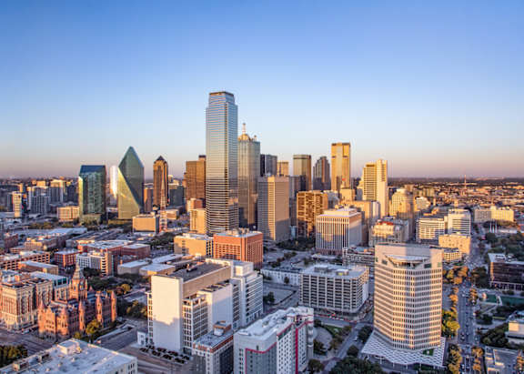 A cityscape with a variety of buildings and a clear sky.