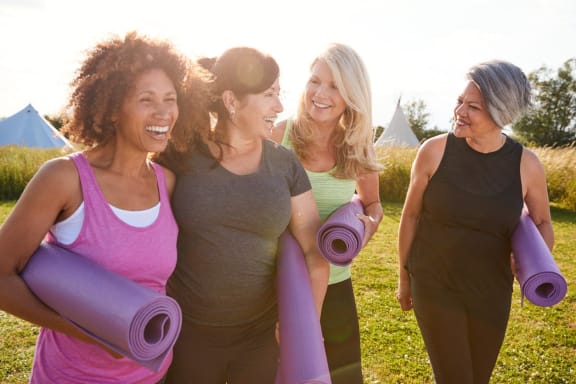 a group of women holding yoga mats in a park at Glenwood at Grant Park Apartments, Atlanta, GA, 30316