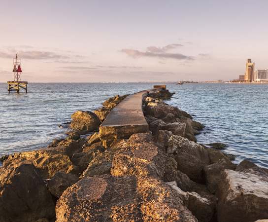 a pier on the water with the city skyline in the background at Candlewood, Texas, 78412