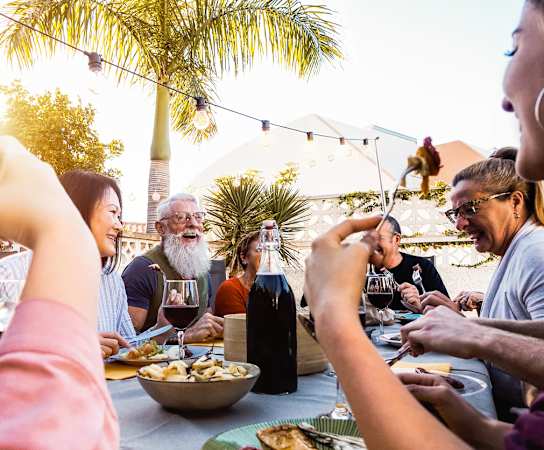 a group of people sitting around a table eating food and drinking wine at 511 Meeting, South Carolina