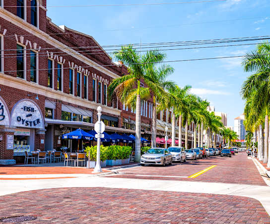 a street in charleston with cars parked on the side of the road and palm trees at Cypress Legends, Fort Myers, FL