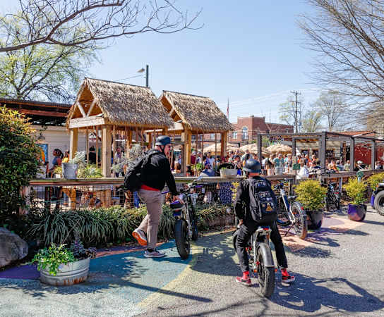 people walking and riding bikes in a parking lot at Randolph Park, Charlotte North Carolina
