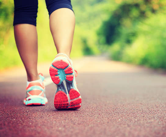 a woman walking on a road at Ballantrae Apartments, Florida