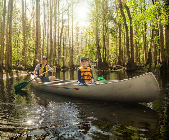 two boys in a canoe on a river at Cypress Legends, Fort Myers, FL