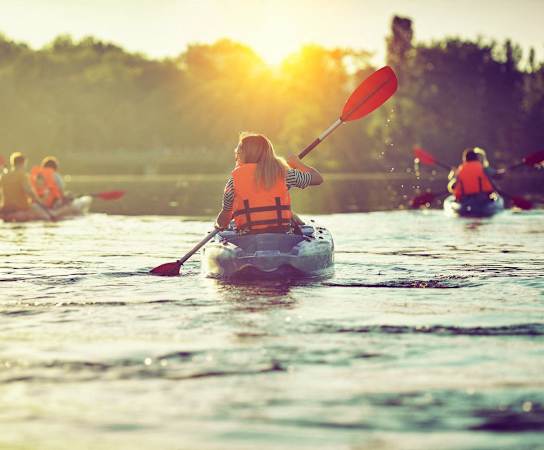 a group of people are kayaking on a river at Cypress Gardens, Texas, 78613