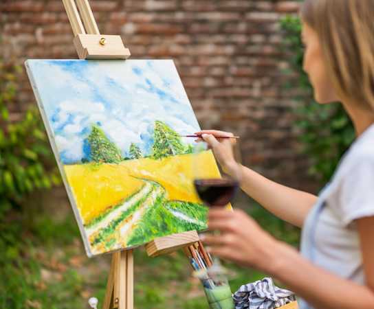 a woman painting a landscape on an easel at The Maven, Georgia, 30024