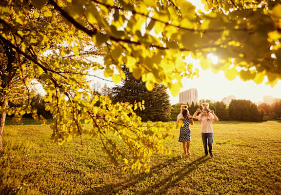 a documentary photograph of a couple walking in the park during their boston engagement session