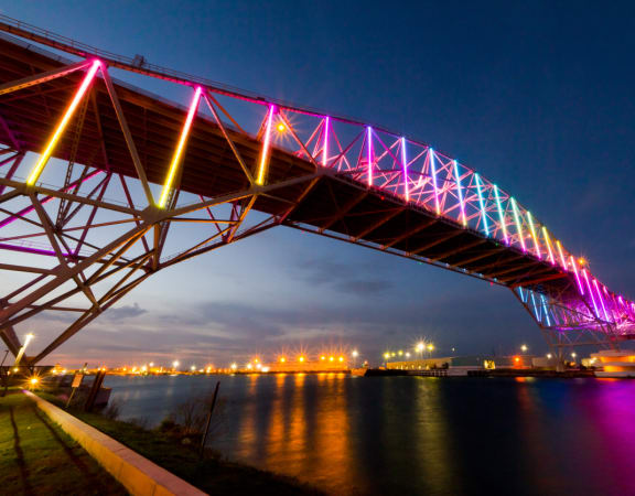the rainbow bridge in portland lit up at night