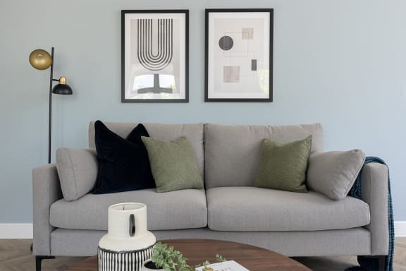 a living room with a couch and a glass table