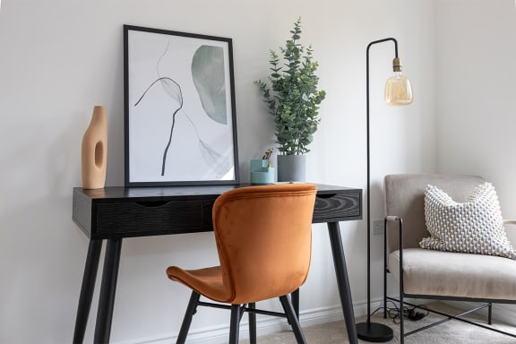 Desk and chair in a living room at Leaf Living home to rent 