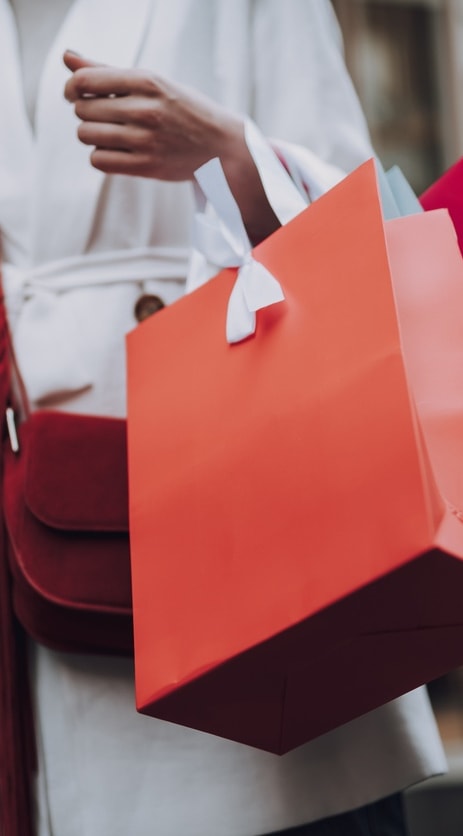 a woman carrying shopping bags and holding shopping bags at The Grove Germantown in Germantown