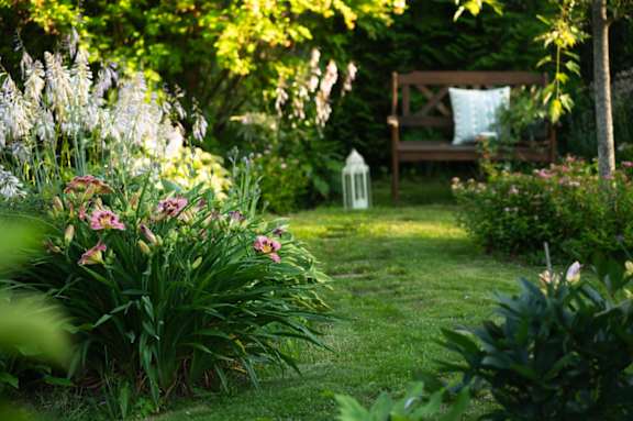 garden with a bench and flowers at Life At Agora, Ohio, 44103
