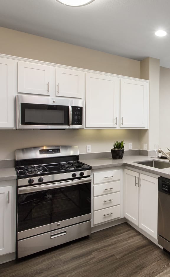 a kitchen with white cabinets and stainless steel appliances at 55+ Remington at Ladera Ranch, Ladera Ranch, CA, 92694