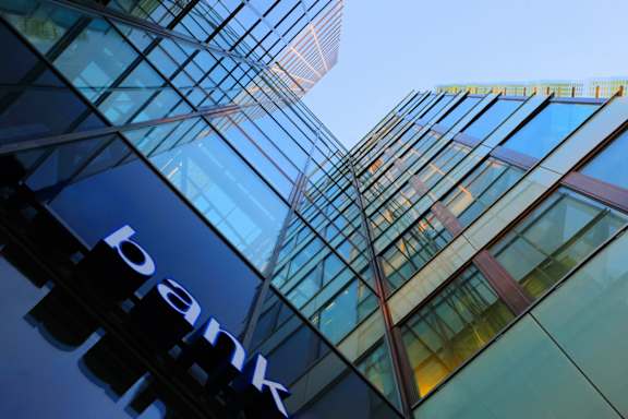 A bank building with a large sign on the side.