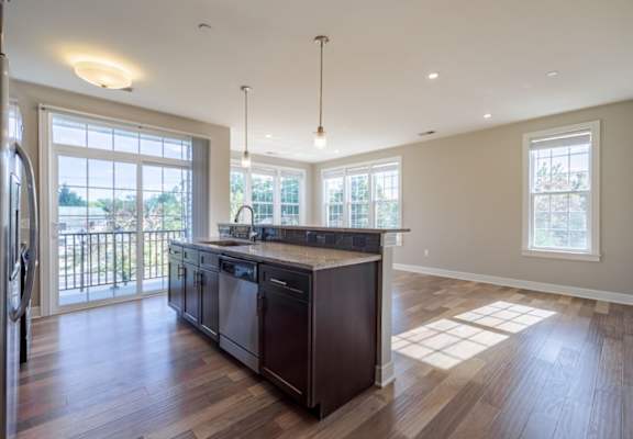 a large kitchen with an island in the middle