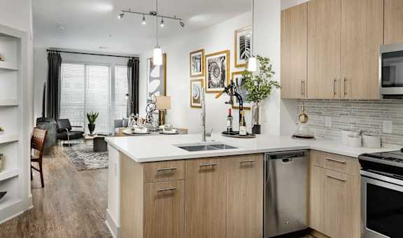 A modern kitchen with wooden cabinets and stainless steel appliances.