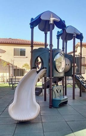 a playground with a slide and a clock