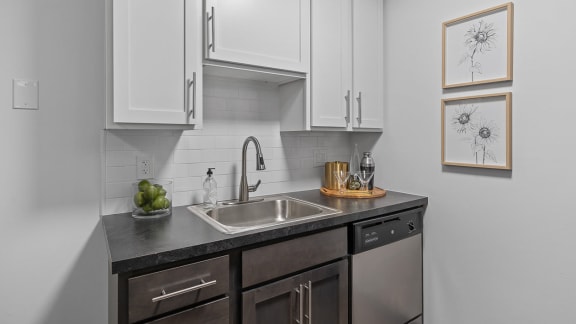 a kitchen with white cabinets and a sink