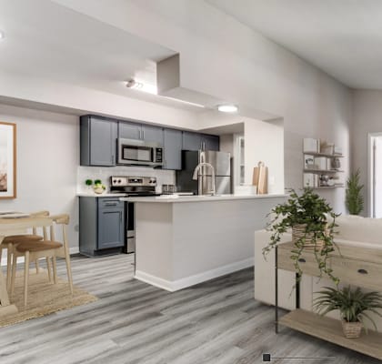 a living room with a couch and a table in front of a kitchen