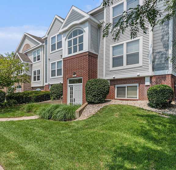 An exterior apartment building with lush landscaping at Gull Prairie/Gull Run Apartments and Townhomes, Kalamazoo, MI