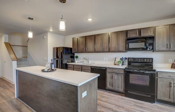 a kitchen with wooden cabinets and a white counter top