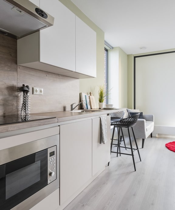 a kitchen with white cabinets and a stove and a sink
