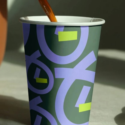 A purple and green cup with the word "LOVE" written on it.