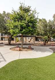 Aerial view of pool area with tropical landscaping at Playa Vista Apartments, Las Vegas, NV