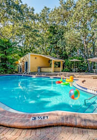 A small pool with a yellow ball in it.