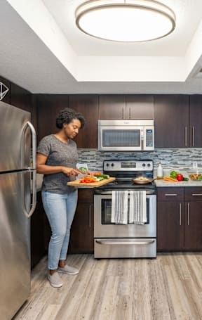 A woman is preparing food in a modern kitchen.